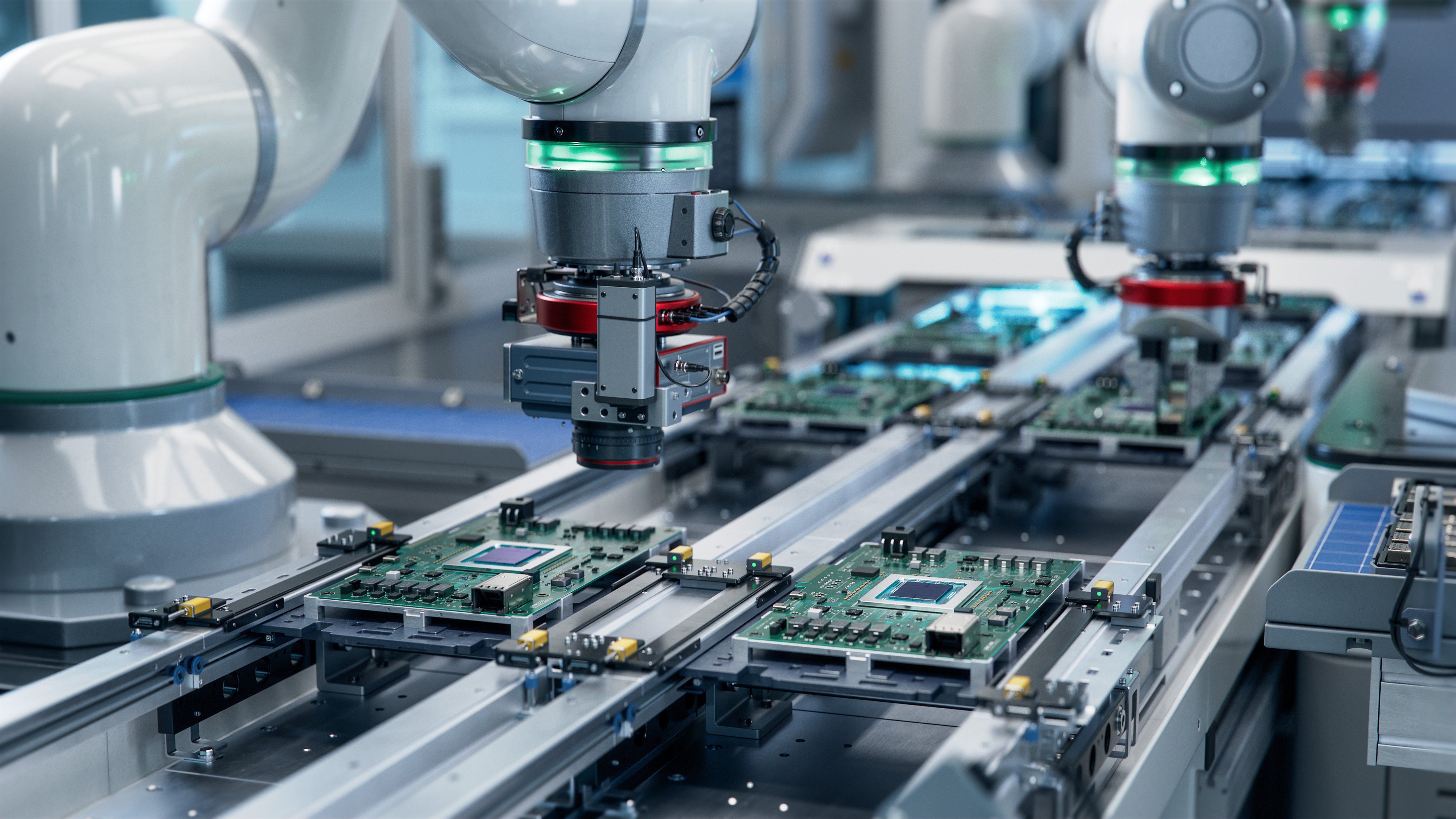 Robotic arms assemble electronic circuit boards on a conveyor belt.